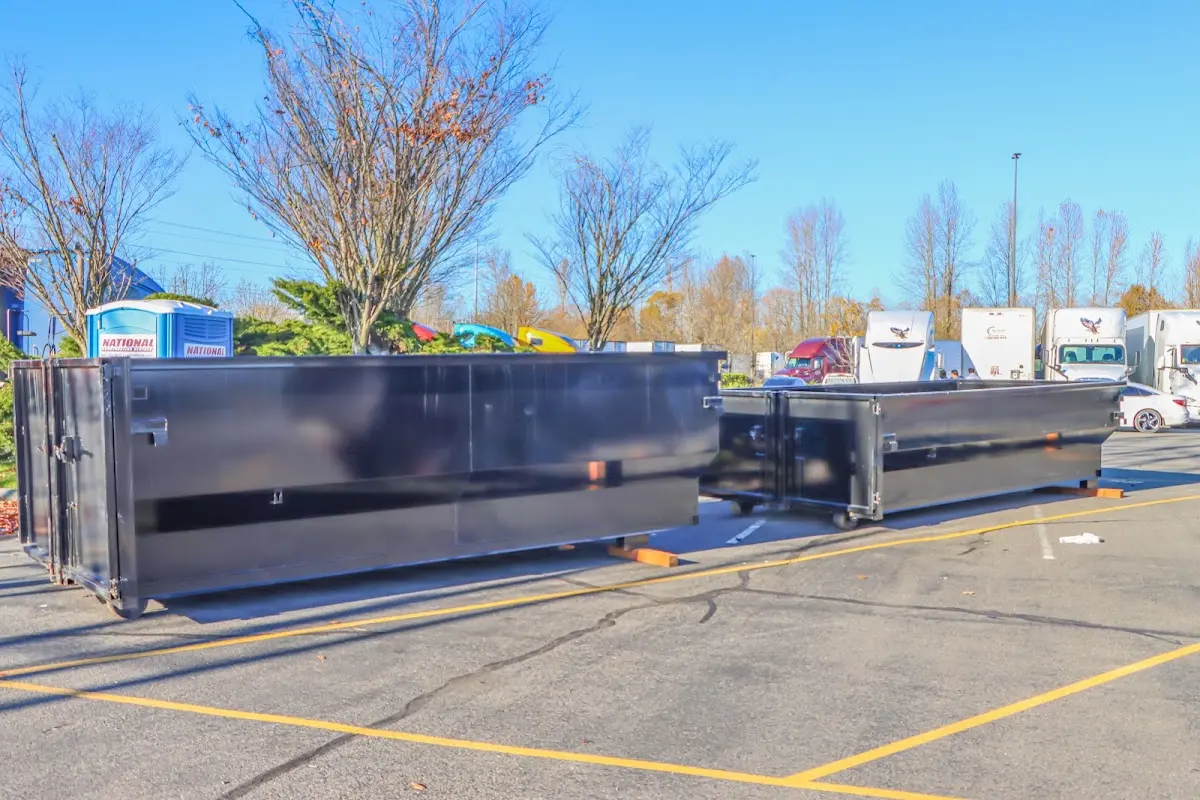 Professional dumpster rental service with roll-off container on residential driveway in Bonham